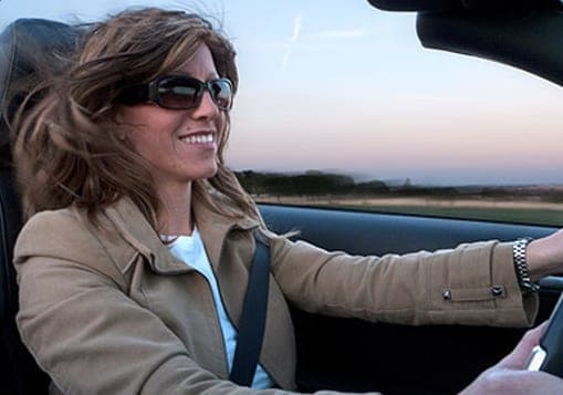 Client driving a convertible, wind in her Angel Wig